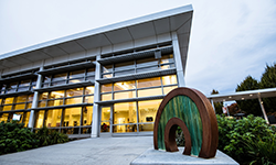 Exterior of a Southeast campus building with a sculpture. 