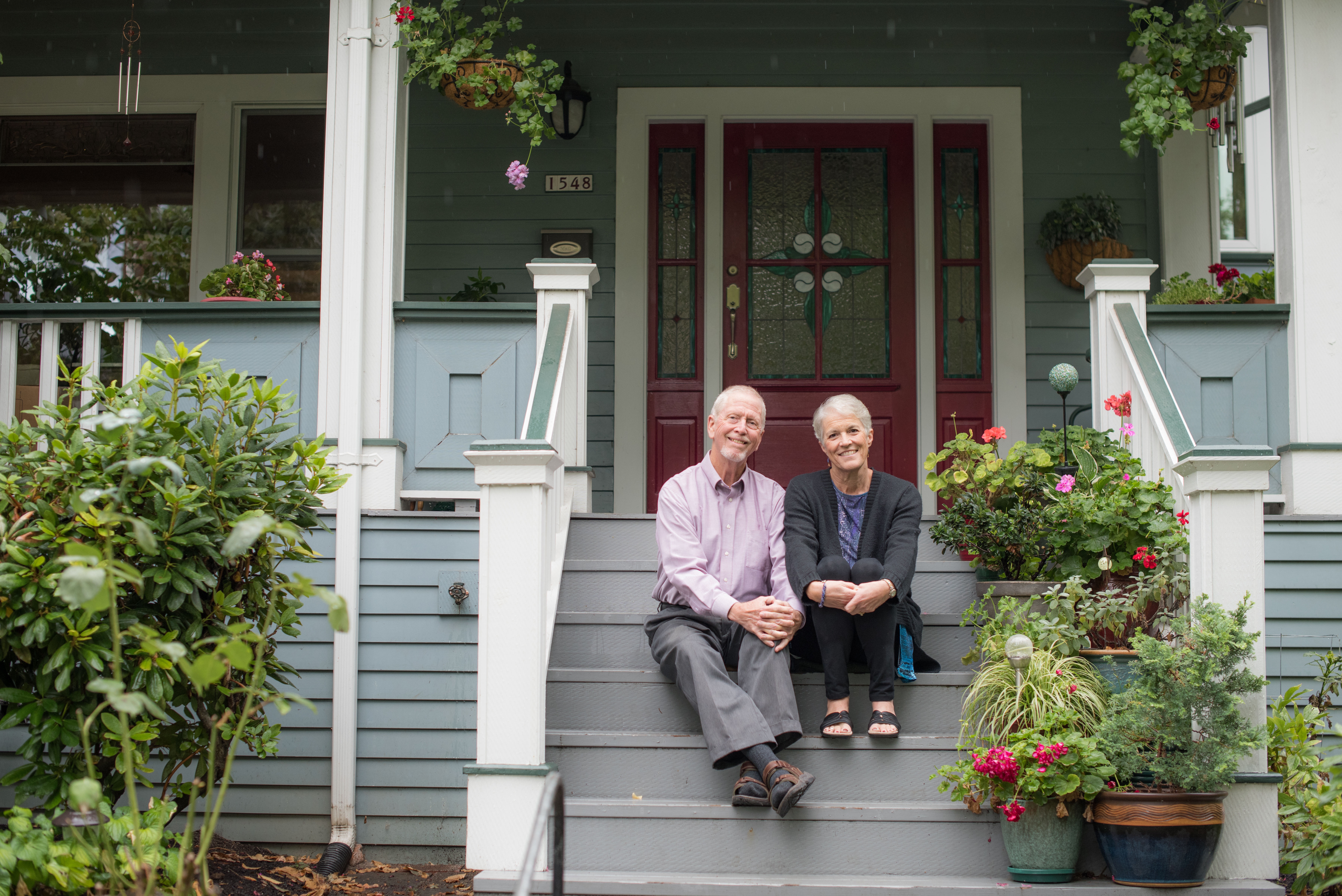 Michael and Ruth Morrow sitting on the steps of their home.